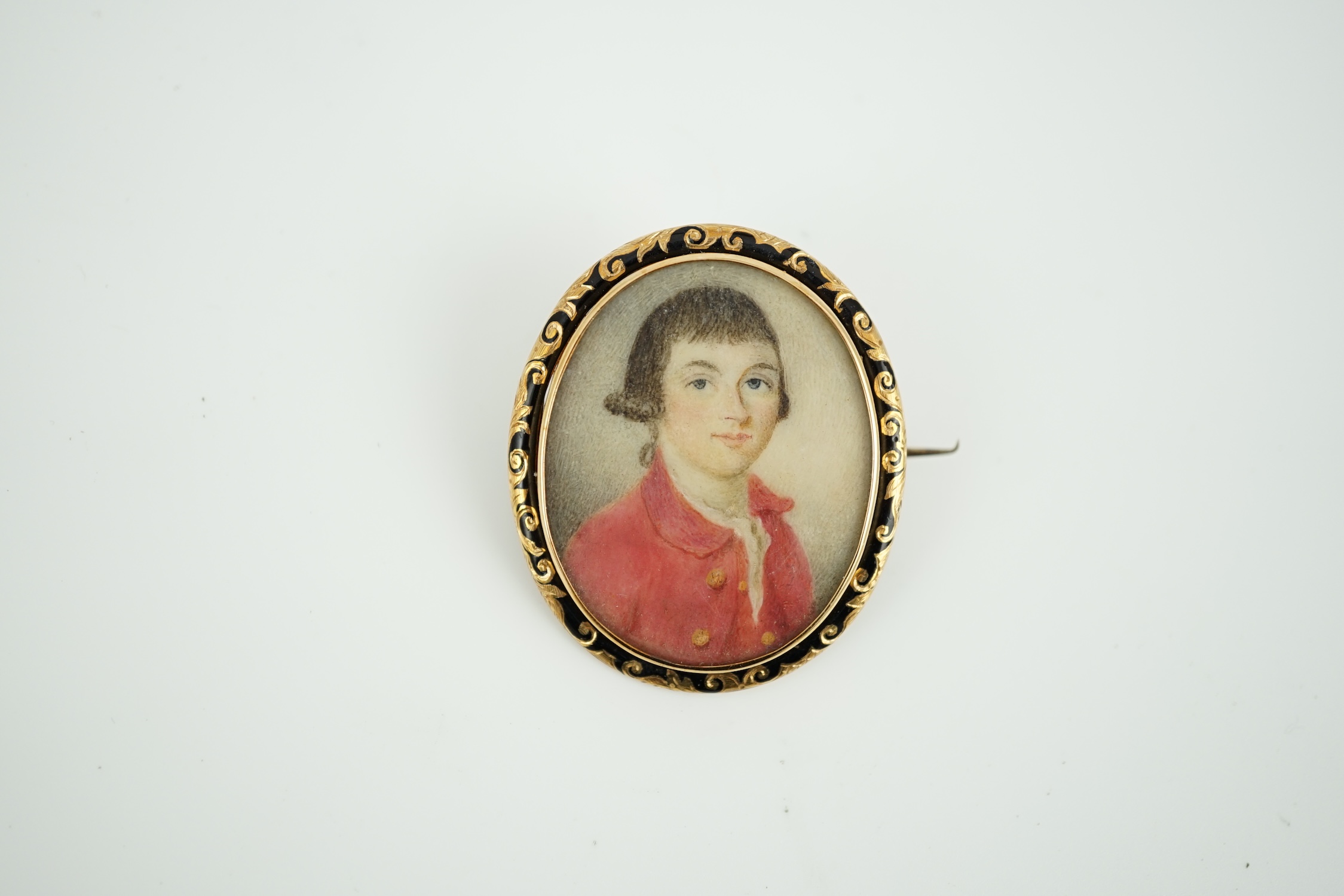 A 19th century yellow metal and black enamel mounted oval portrait miniature of a young gentleman, 42mm.